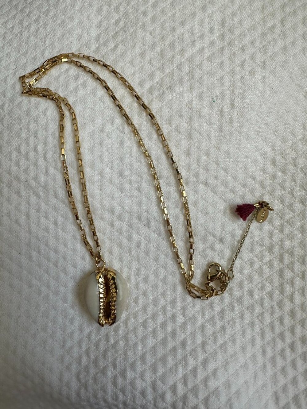 SHASHI Gold Cowrie Shell Pendant Necklace with Tassel Accent